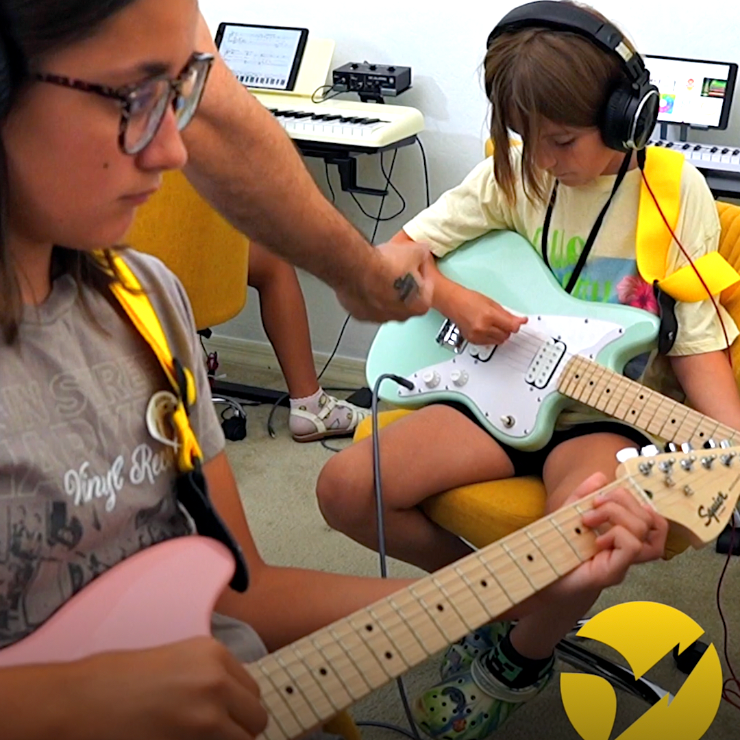 Kids playing electric guitars in Guitar Lab
